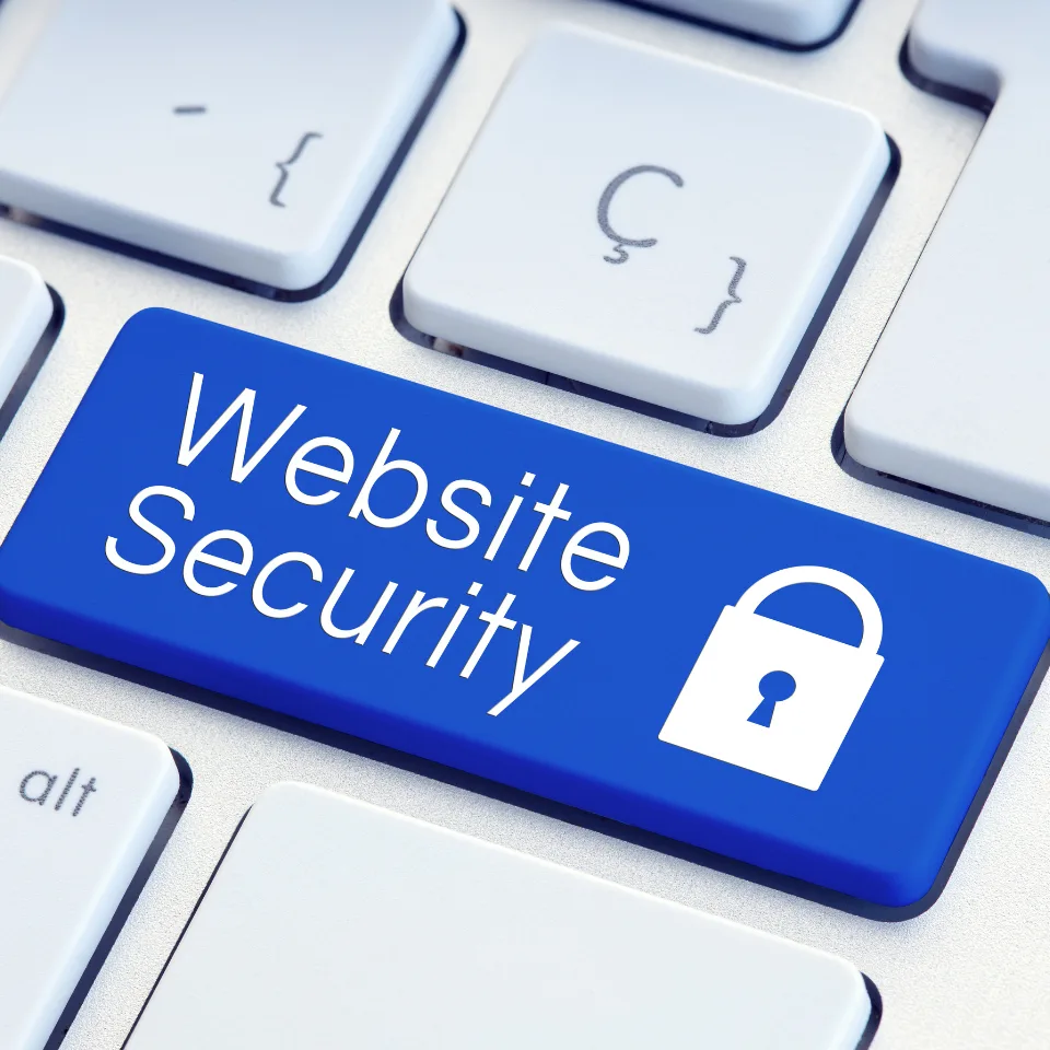 Blue keyboard key labeled 'Website Security' with white padlock icon on white computer keyboard for online safety concept